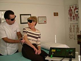 Patient receiving laser treatment to elbow